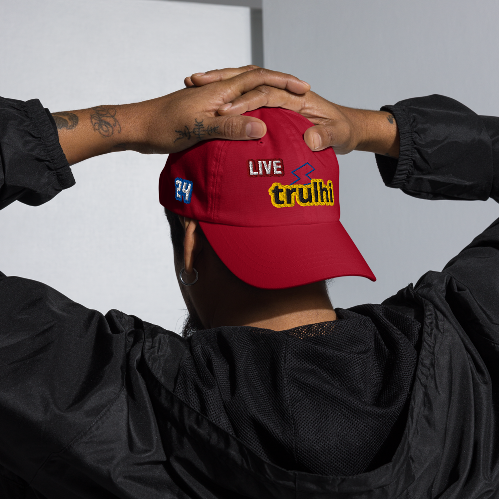 Red cap with 'trulhi' branding held by two people against a neutral background
