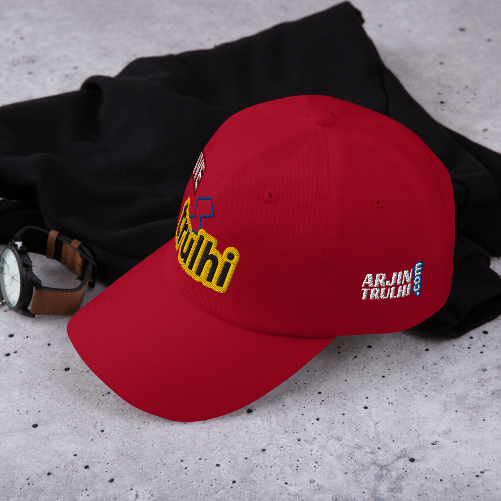 Red cap with branding on a gray surface